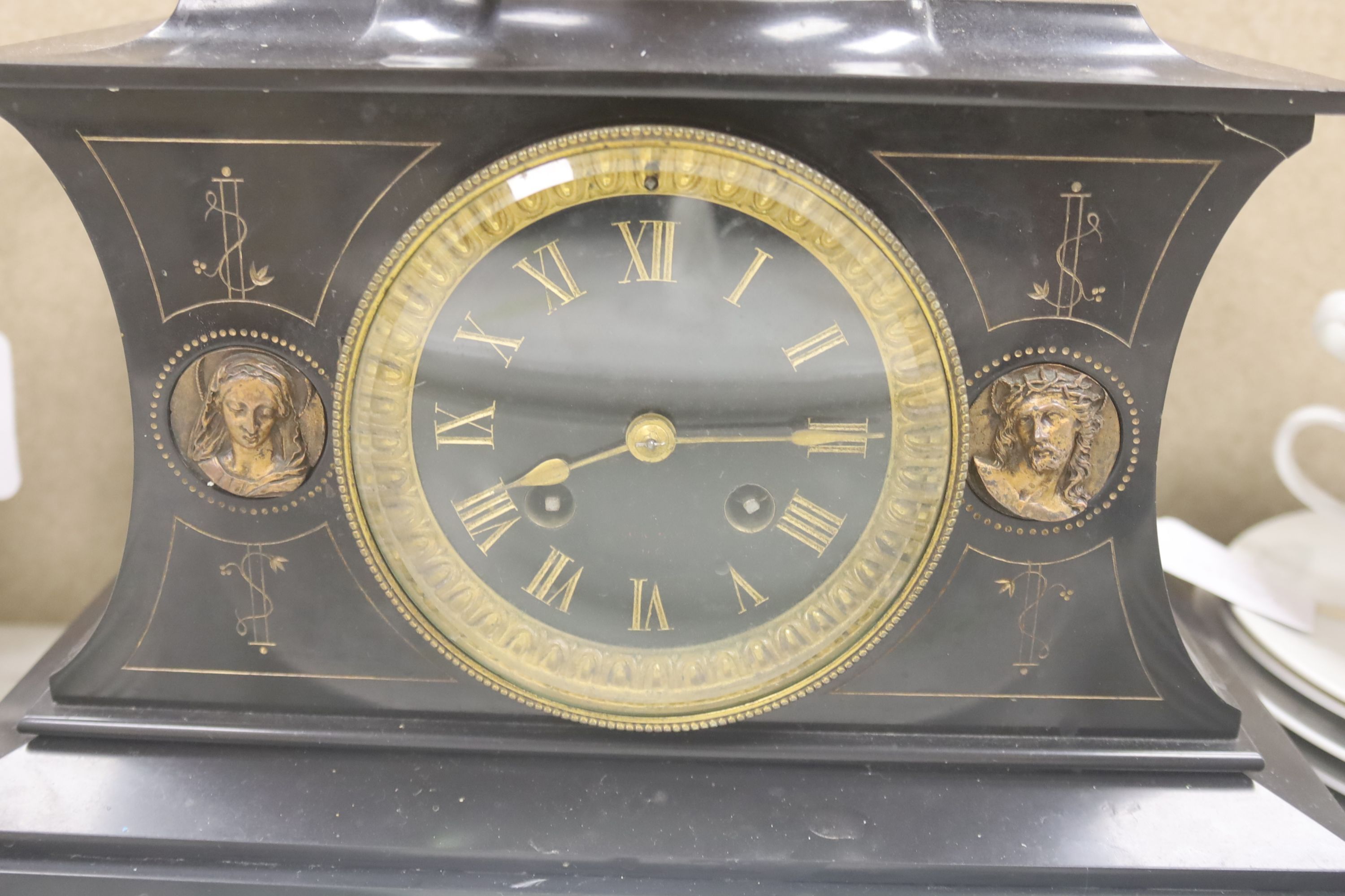 An ecclesiastical black slate mantel clock, height 21cm